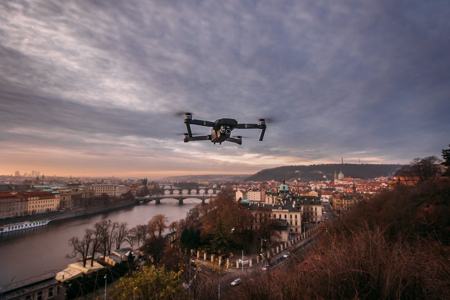 Surveillance drone over a city at dusk